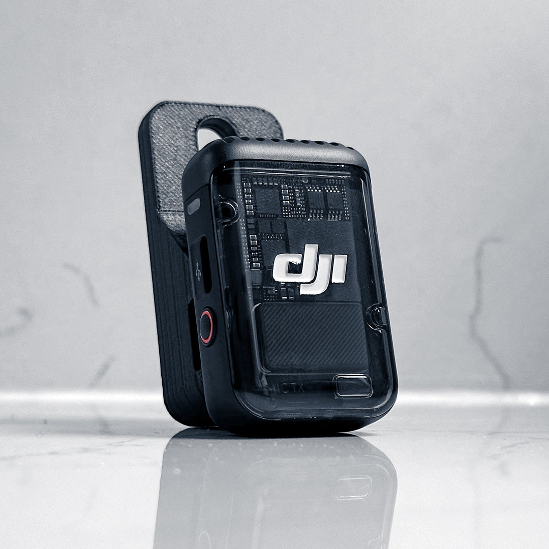 The MicDrop wireless mic mount securely attached to a DJI Mic 2 in Black, ready to capture high-quality exhaust audio without wind noise.